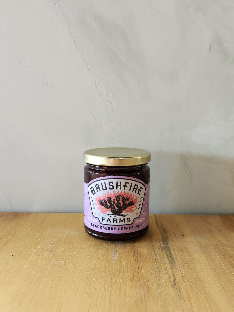 a jar of blackberry pepper jam made in texas.