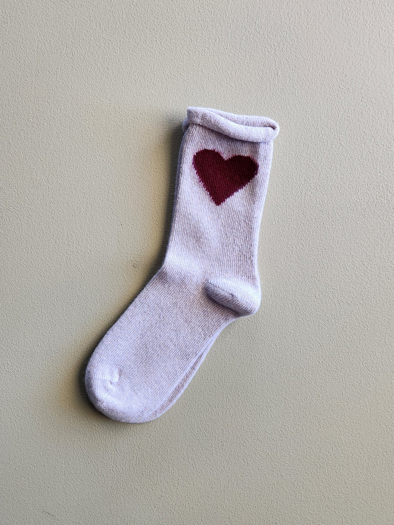 Beige cashmere women's crew sock with a dark red heart on the side.