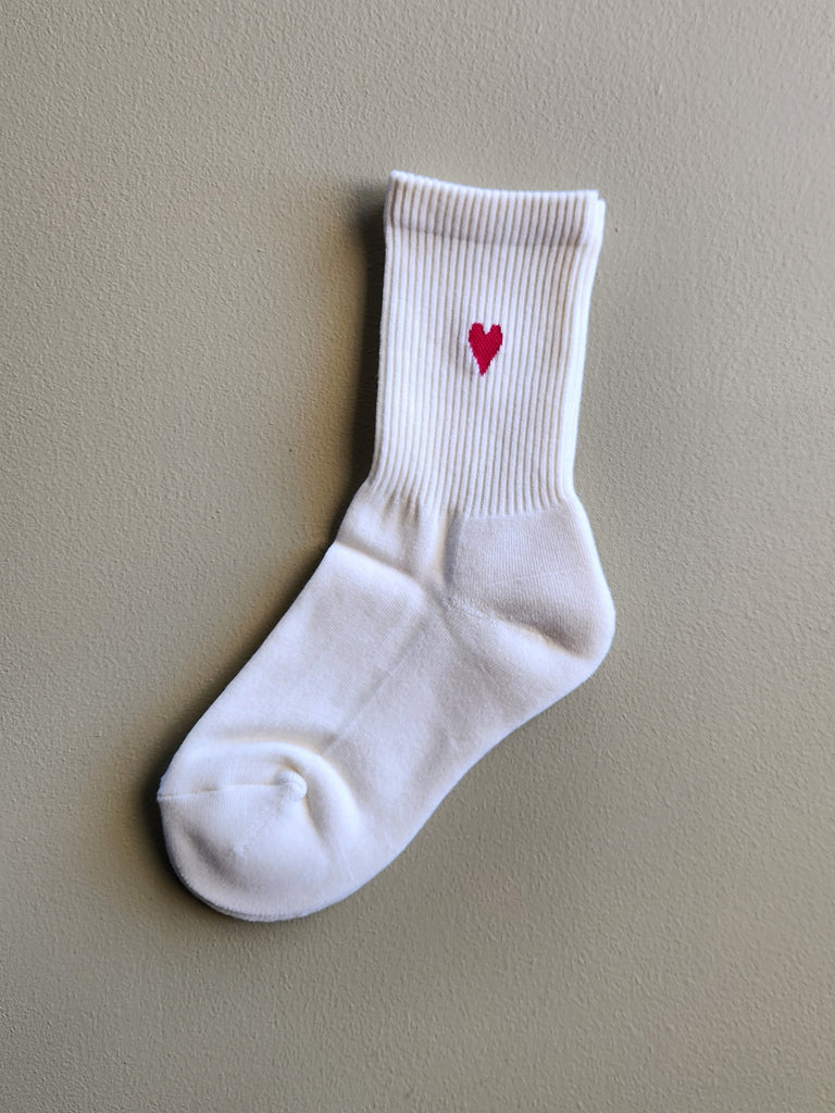 Cream cotton tube sock with small heart on ankle.