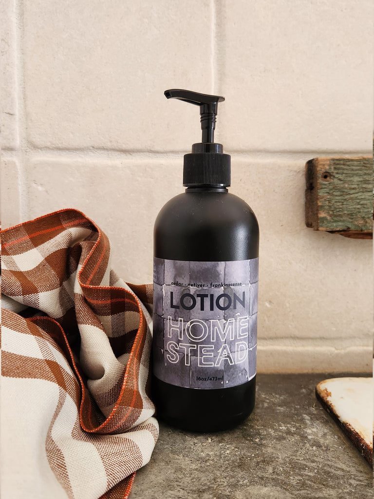 A 16oz black bottle of lotion scented with cedar vetiver and frankinscense essential oils. 