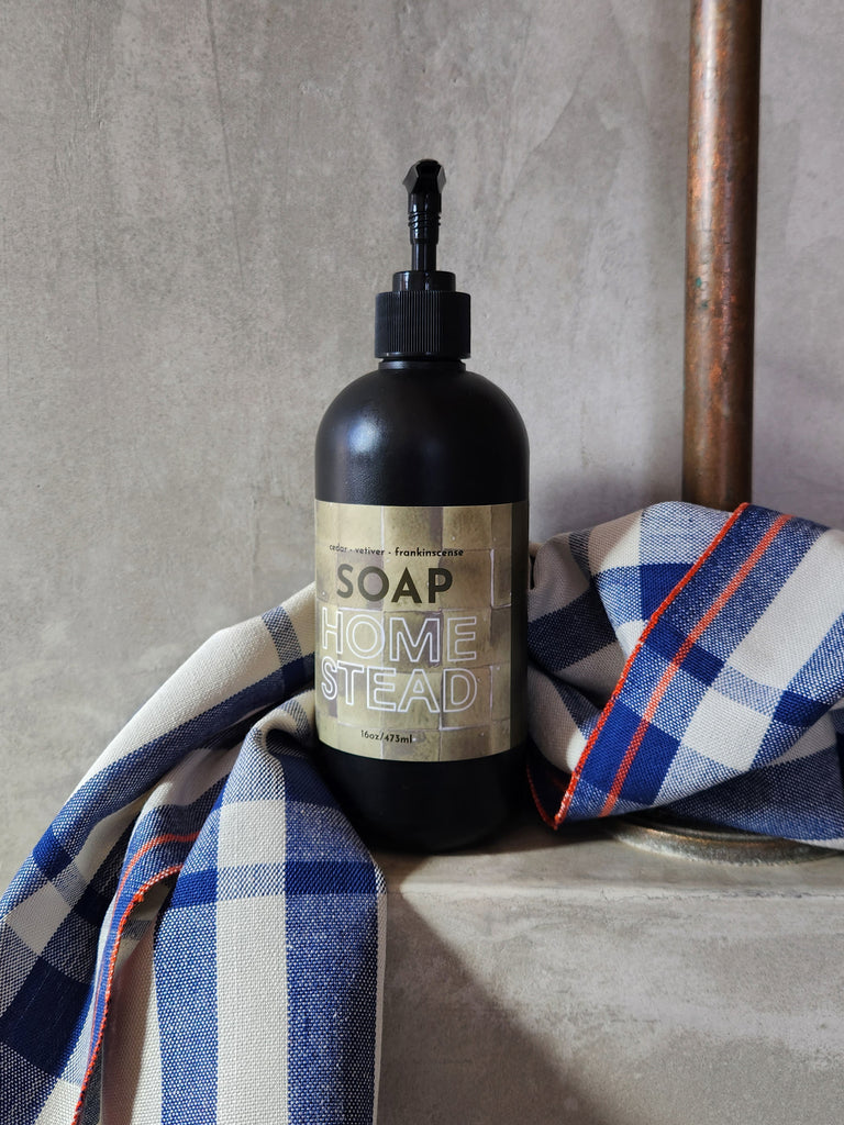 A 16oz black bottle of liquid soap scented with cedar, vetiver and frankinscense essential oils. 