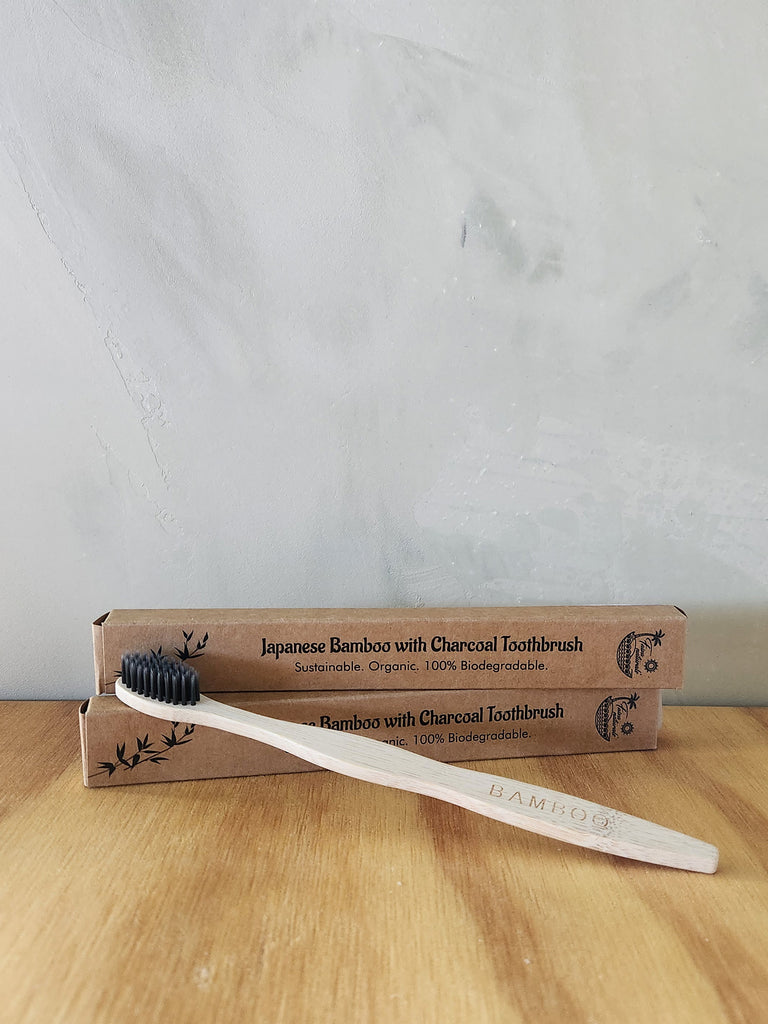  A bamboo wood toothbrush with charcoal bristles.