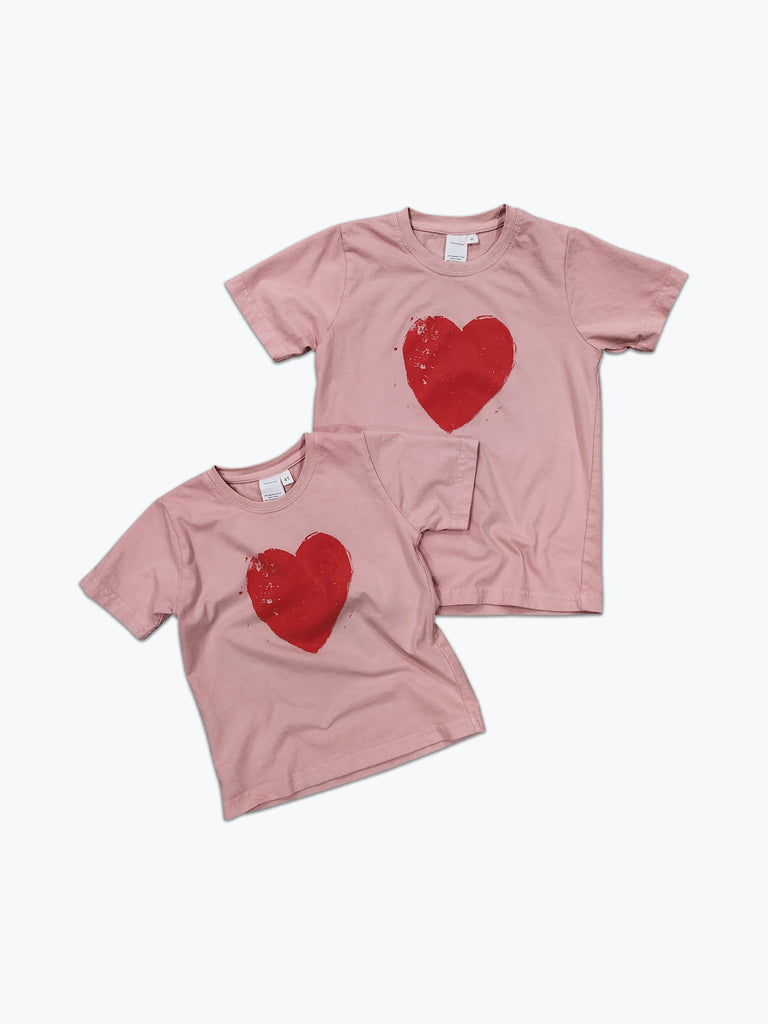 Dusty pink t-shirt with a large red heart screen printed on it. 