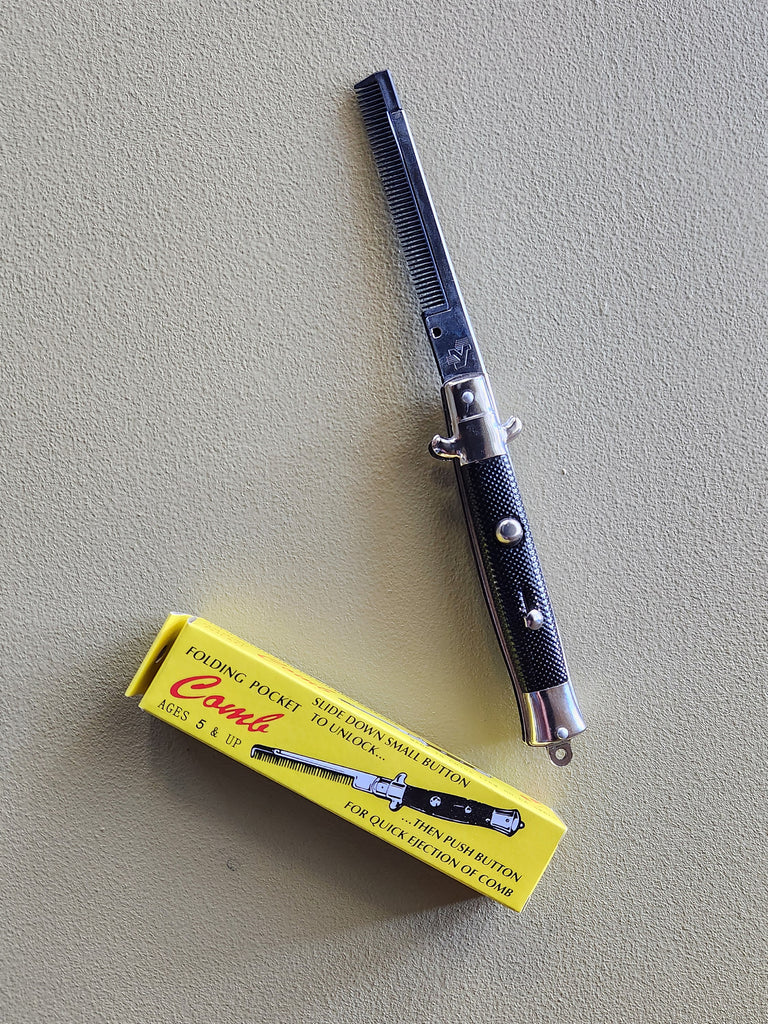 A toy switchblade comb. 